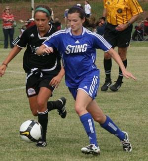 Girls club soccer players compete in a club soccer tournament.