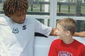 Elite club soccer player talks to coach.