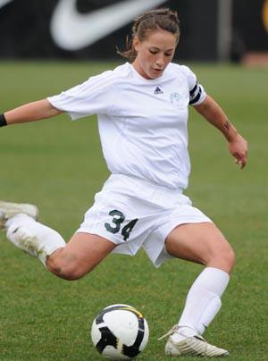 Elite club soccer player kicks the ball.