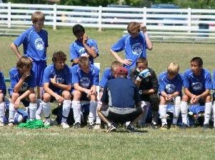 A club soccer coach talks to his players.
