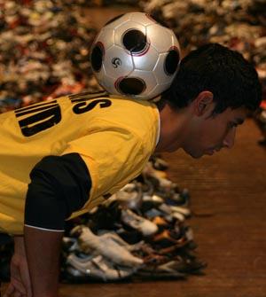 Abbas Fraid stalls the soccer ball on his neck.