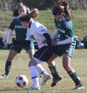 Elite girls club soccer players compete.