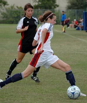 Girls club soccer players compete.