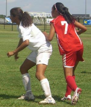 Girls club soccer players compete in a club soccer tournament.
