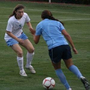 Elite club girls soccer players compete.