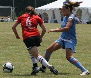 Elite club girl soccer players compete.