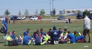 An unidentified club soccer team talks it over after its match on Monday at the 30th Dallas Cup.