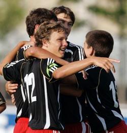 Elite club soccer players celebrate.