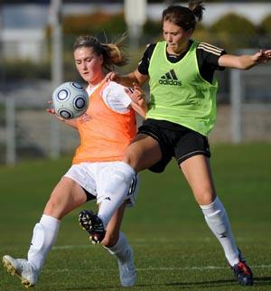 Elite club soccer players compete.