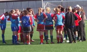 Elite club soccer playes huddle.